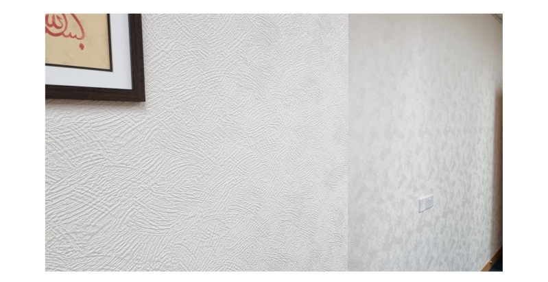 Textured white wallpaper with framed artwork